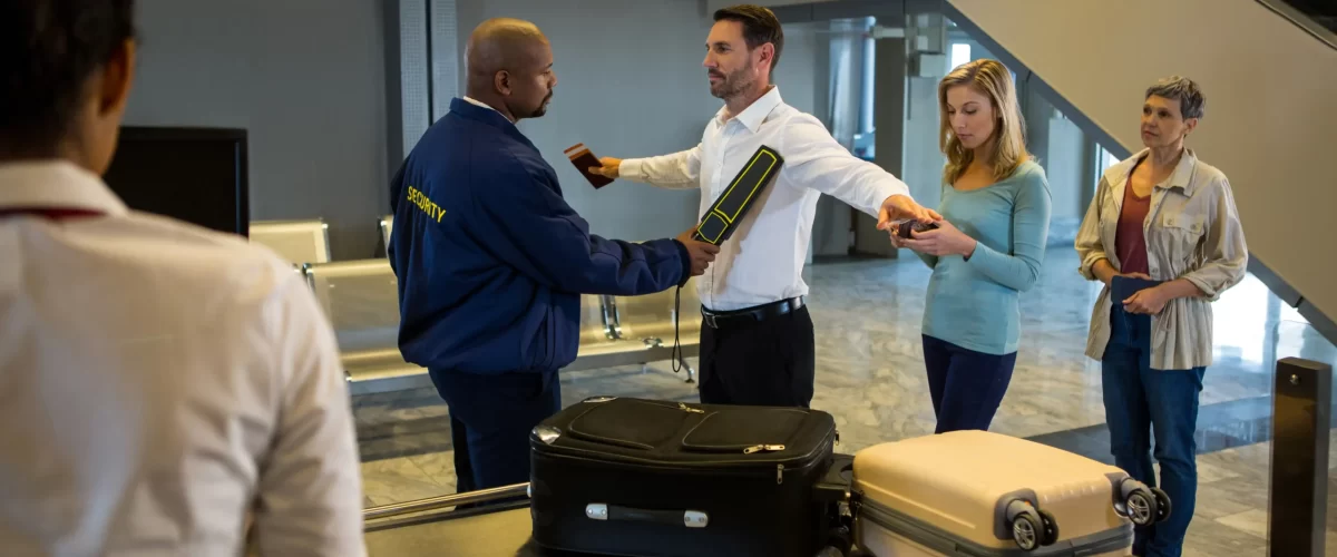 security-guard-frisk-passengers-standing-queue